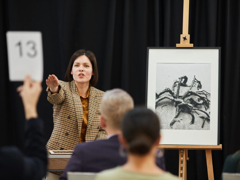 Businesswoman,Pointing,At,Woman,With,Sign,And,Selling,Her,The